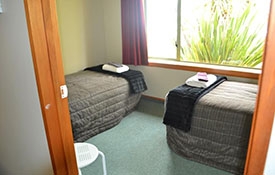 two single beds in the second room of family unit
